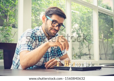 Casual businessman playing chess game with retro style photo, in business competition and planning strategies concept.