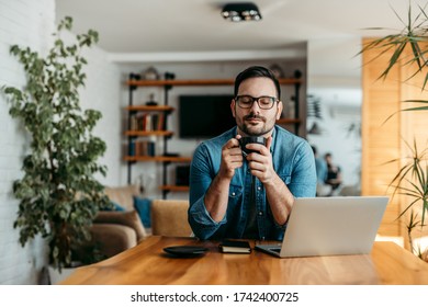 Casual businessman relaxing with a cup of coffee, portrait.