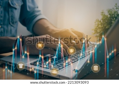 Casual Businessman Using or Typing Laptop and Online Product Icon, Color Stock Market Bar Chart and Line Graph Trend. Consumer Discretionary Sector and Financial Economy Concept in Vintage Tone