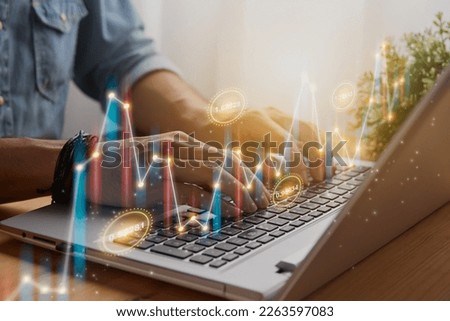 Casual Businessman Using and Typing Laptop Computer with Color Slant Number Value Stock Market Bar Chart and Line Graph Trend. Financial Economy and Business Growth Concept
