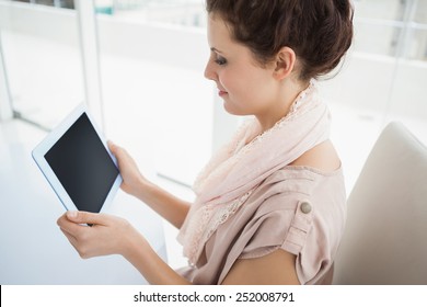 Casual businesswoman holding digital tablet in the office