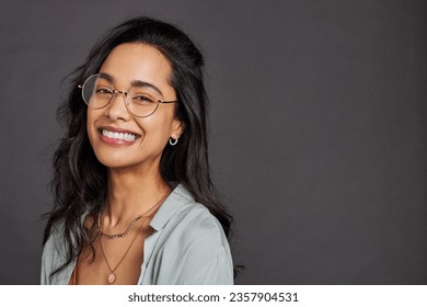 Casual cheerful young woman with eyeglasses smiling at camera on gray background. Close up face of happy multiethnic girl laughing with trendy eyeglasses and copy space. Beautiful mixed race girl. - Shutterstock ID 2357904531