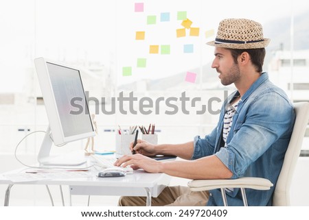 Casual designer using computer and digitizer in the ofice