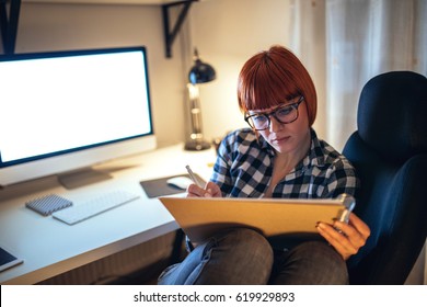 Casual designer working late at night at home. - Shutterstock ID 619929893