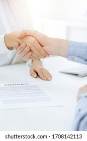 Casual Dressed Businessman And Woman Shaking Hands After Contract Signing In Sunny Office. Handshake Concept