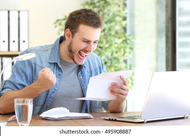 Casual excited entrepreneur reading a letter with good news in a desktop at workplace