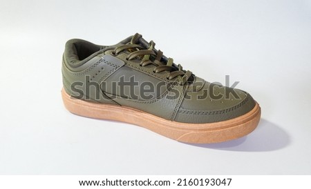
Casual green olive green sneakers for men and women with brown soles with white background