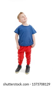 Casual little boy looking on copy space. Isolated on white background 