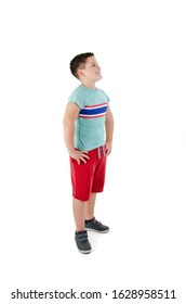 Casual little boy looking on copy space. Isolated on white background 