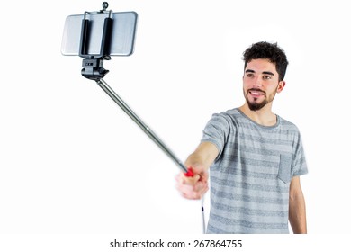 Casual Man Using A Selfie Stick Shot In Studio