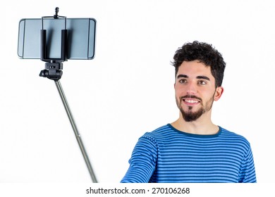 Casual Man Using A Selfie Stick Shot In Studio