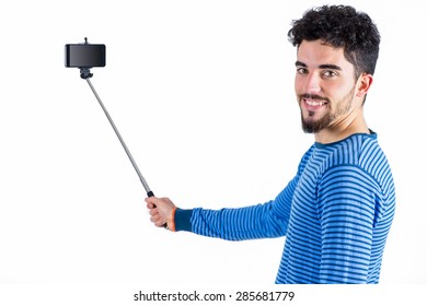 Casual Man Using A Selfie Stick Shot In Studio