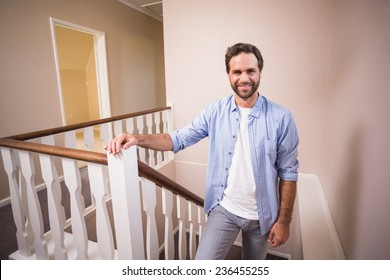 Casual Man Walking Up The Stairs In His New Home