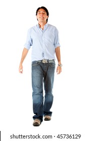 Casual Man Walking Towards The Camera Isolated Over A White Background