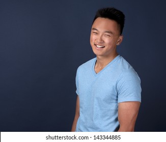 Casual Man Wearing Blue Tshirt And Jeans On Dark Background