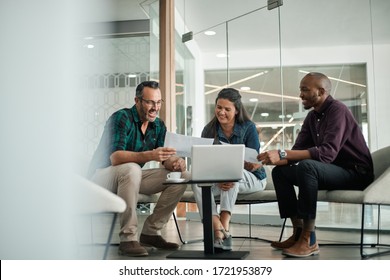 Casual meeting of smiling diverse business team analyzing financial data - Powered by Shutterstock