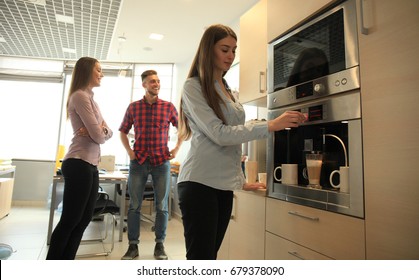 Casual Office People Talking By The Coffee Maker.