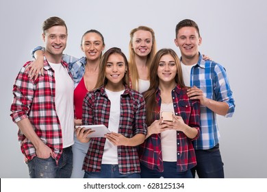 Casual People Group, Young Man And Woman Using Tablet Computer Happy Smile Handsome Guys Beautiful Girls Over Grey Background