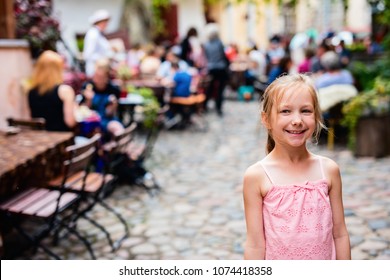 Casual Portrait Of Little Girl Outdoors In Tallinn Old Town On Summer Day