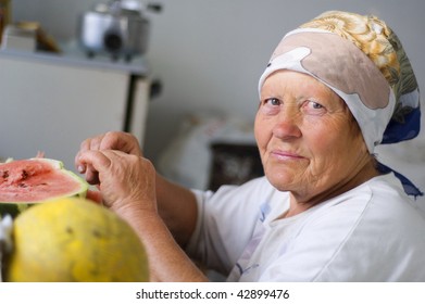 Casual Portrait Of Old Woman Eating A Watermelon