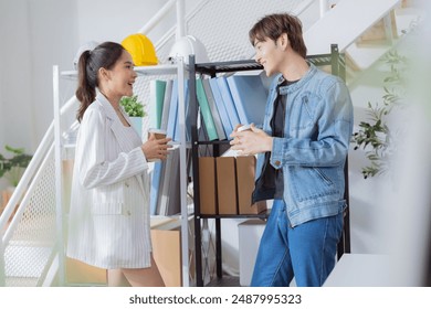 casual relax cinversation in break time two busness male and female person creative agent casual talking standing in office after seminar business meeting in modern office interior business concept - Powered by Shutterstock