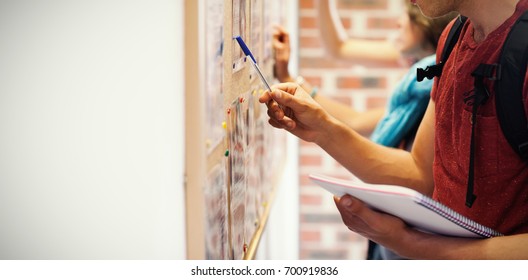 Casual Students Searching Something On Notice Board In College