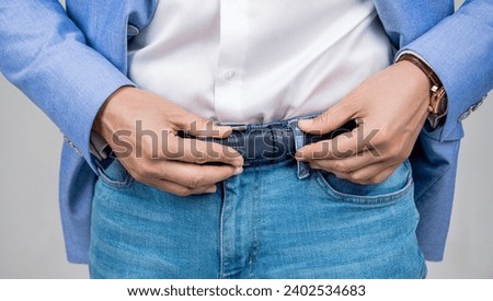 Casual style of man, closeup. Male accessory for man in menswear. Jeans belt. Menswear for man wearing jeans and belt. Man in jeans unbutton belt [[stock_photo]] © 