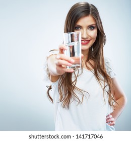 Casual style young woman posing on isolated studio background, hold water glass. Beautiful girl portrait. Female model poses.