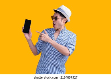 casual traveller male adult wear hat  relax leisure hand hold coffee cup standing while smartphone checking booking flight and hotel online reserve smart travel application online platform studio shot - Powered by Shutterstock