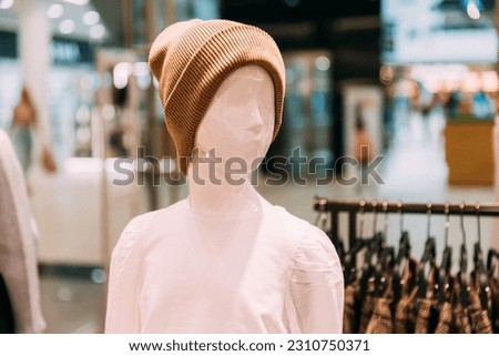 Casual warm Hat On Mannequin In Store Of Shopping Center. shelf display in shop mall store. Store Of Shopping Center. retail sale.