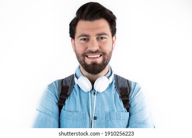 Casual Wear Content Young Man Posing With Backpack And Headphones. Student And Education Concept Isolated On White Background.