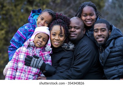 Casual Winter Young Black Family Outdoors In The Park