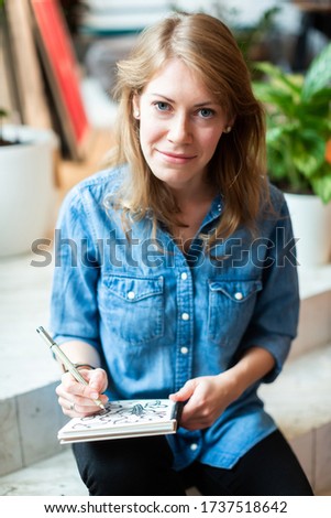 Similar – Happy girl using a smart phone sitting on a couch at home