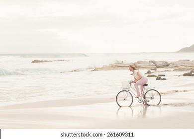 Casual Woman On A Bike Ride At The Beach