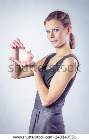 Casual woman with a piggy bank. Isolated over white background 