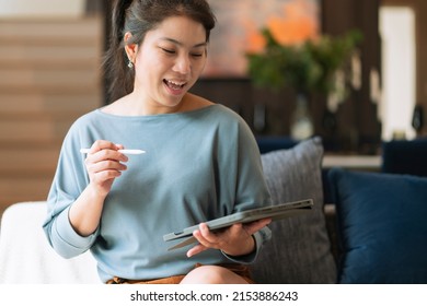 Casual Working At Home Relax Casual Using Tablet Device In Living Room,asian Female Adult Hand Typing Search Or Texting Via Laptop Sofa Working From Home With Happiness Peaceful Smiling Ideas Concept