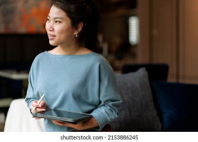 Casual Working At Home Relax Casual Using Tablet Device In Living Room,asian Female Adult Hand Typing Search Or Texting Via Laptop Sofa Working From Home With Happiness Peaceful Smiling Ideas Concept