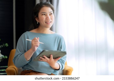 Casual Working At Home Relax Casual Using Tablet Device In Living Room,asian Female Adult Hand Typing Search Or Texting Via Laptop Sofa Working From Home With Happiness Peaceful Smiling Ideas Concept