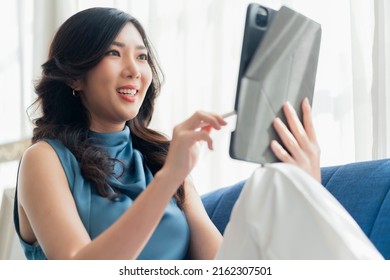 Casual Working At Home Relax Casual Using Tablet Device In Living Room,asian Female Adult Hand Typing Search Or Texting Via Laptop Sofa Working From Home With Happiness Peaceful Smiling Ideas Concept