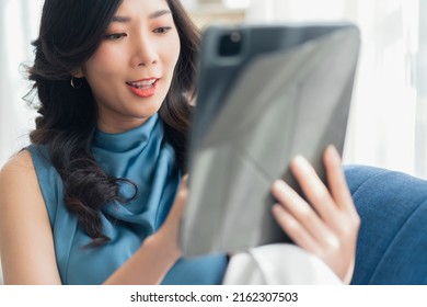 Casual Working At Home Relax Casual Using Tablet Device In Living Room,asian Female Adult Hand Typing Search Or Texting Via Laptop Sofa Working From Home With Happiness Peaceful Smiling Ideas Concept