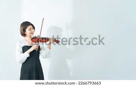 Casual young asian woman with violin.