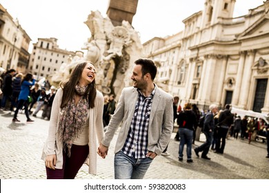 Casual Young Couple Holding Hands Walking In Rome, Italy, Europe.