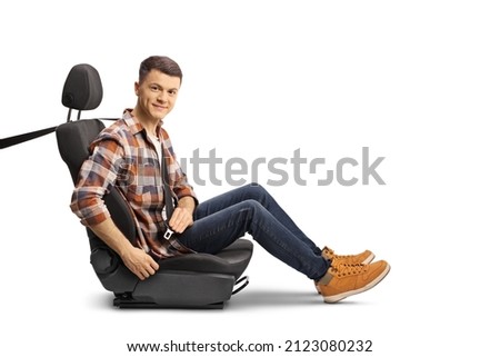 Casual young man buckling up a seat belt and looking at camera isolated on white background 商業照片 © 