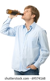 Casual Young Man Drinking Bottle Of Beer. Isolated On White.?