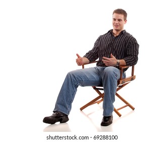 Casual Young Man Seated In Directors Chair.