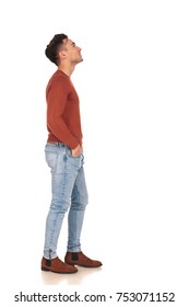 Casual Young Man Standing In Line Is Looking Up At Something On White Background