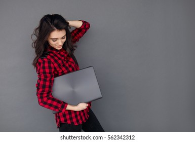 Casual Young Woman Holding A Brand New Laptop