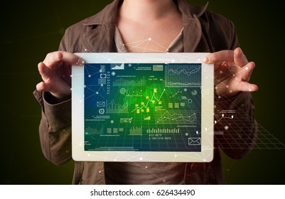 Casual young woman holding tablet with strategy and business related graphics - Shutterstock ID 626434490