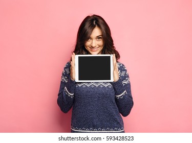 Casual young woman showing a clean tablet screen