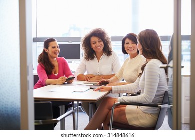 Casually Dressed Female Colleagues Talking In A Meeting Room